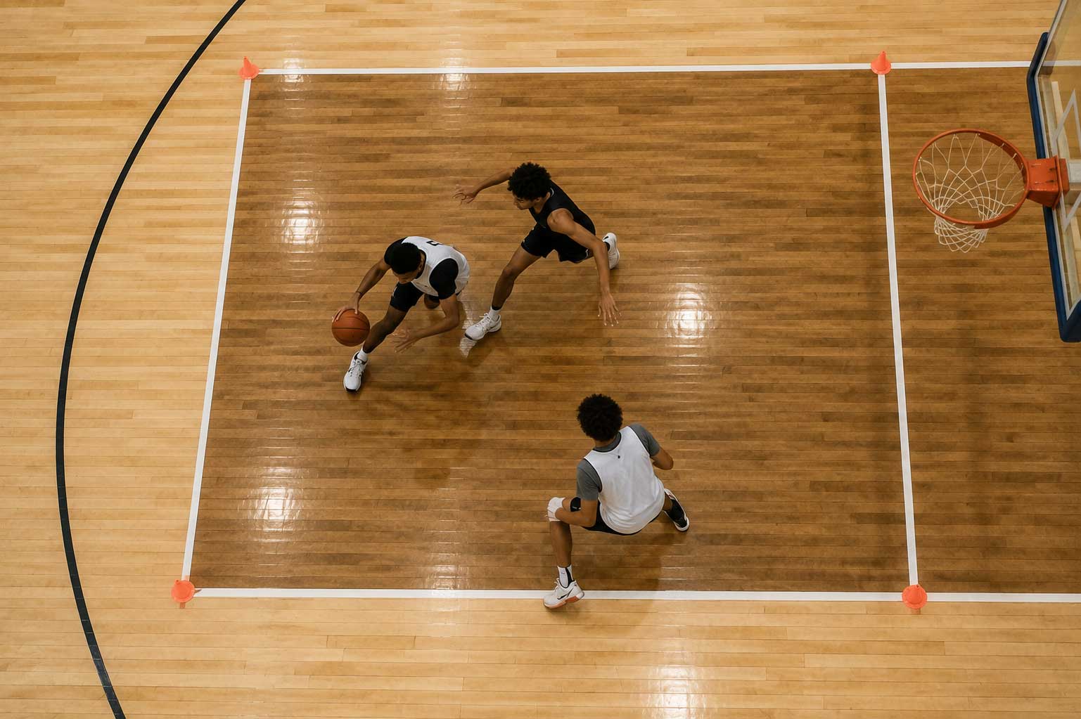 Aerial view of players moving through a small-sided basketball game on an indoor court.